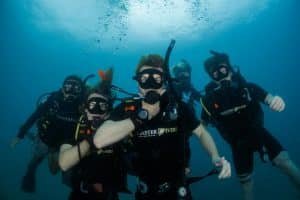 Happy divers under water