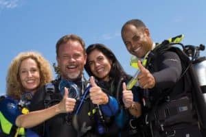 group of divers thumbs up