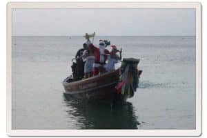 santa arriving on a longtail