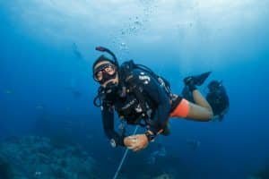 smiling female diver with group in the background 1