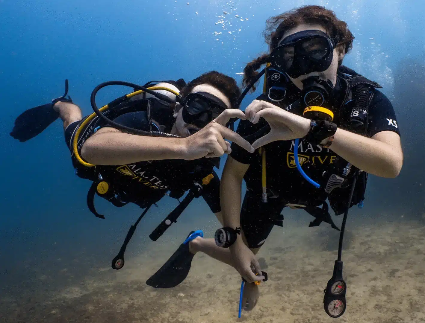 Divers making heart sign